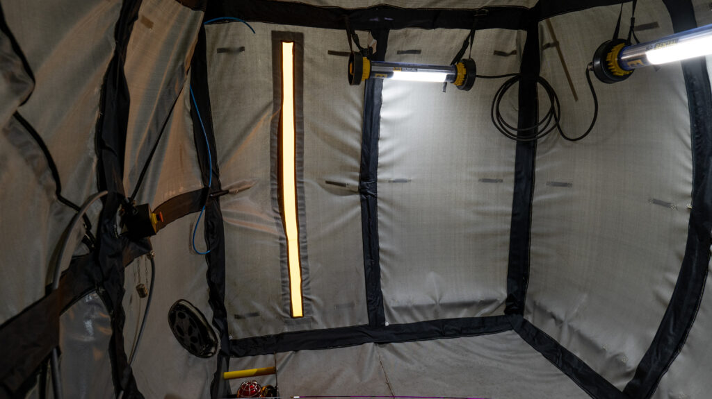 Hot-work habitat internal photo showing emergency escape and SA Equip worklights illuminated